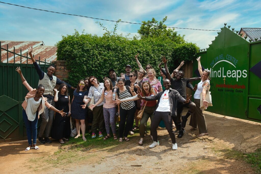 Group of adults in Rwanda make fun poses outdoors