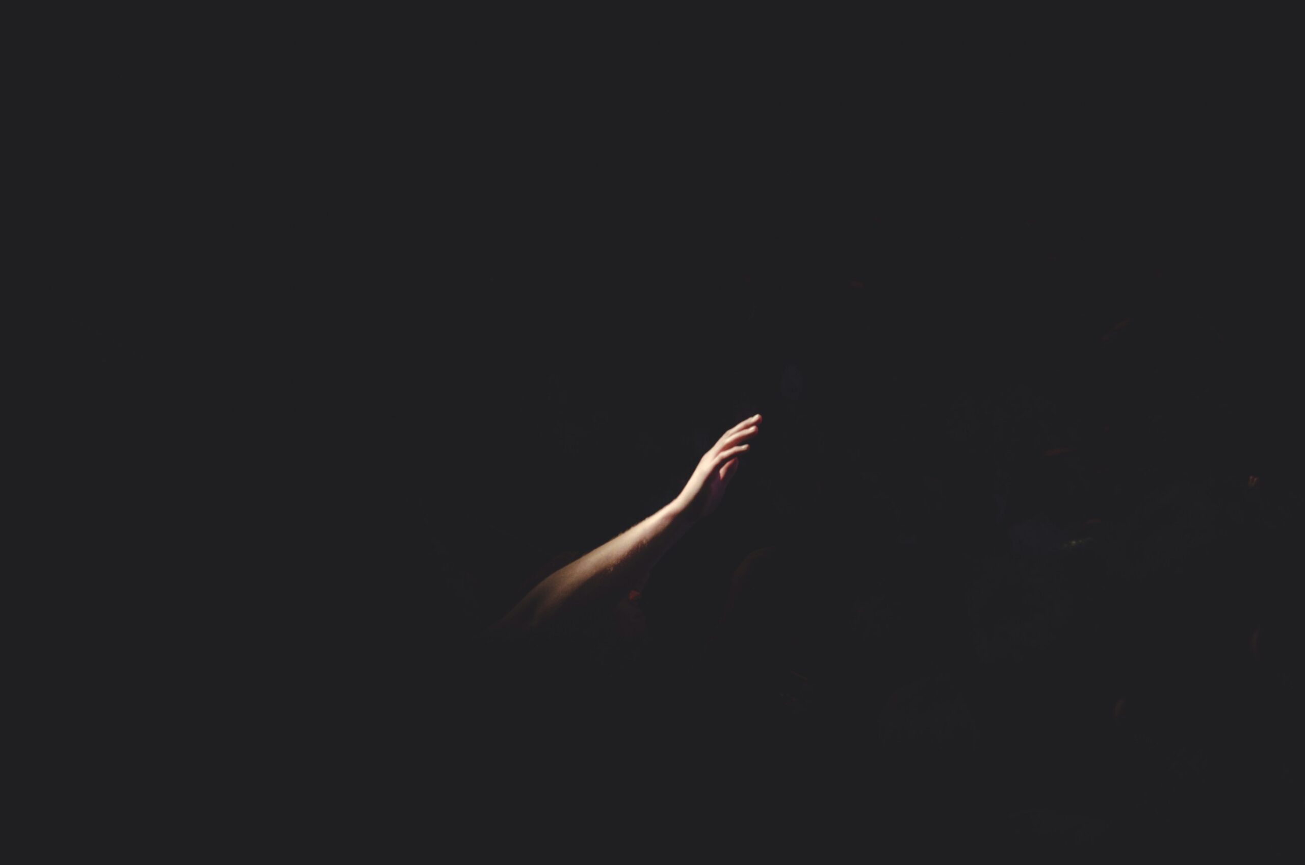 A hand coming out of darkness