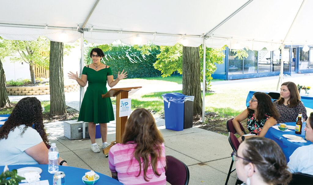 A Young woman speaks to an audience of young professionals in Ann Arbor Michigan.