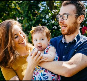 Moishe House Alumni Ally Berman and Michael Godin holding their daughter