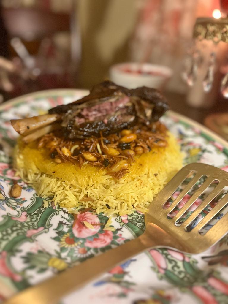Photo of Timmen Qouzi (Or Qouzi Ala El-Timmen): Braised lamb over special rice on a floral plate