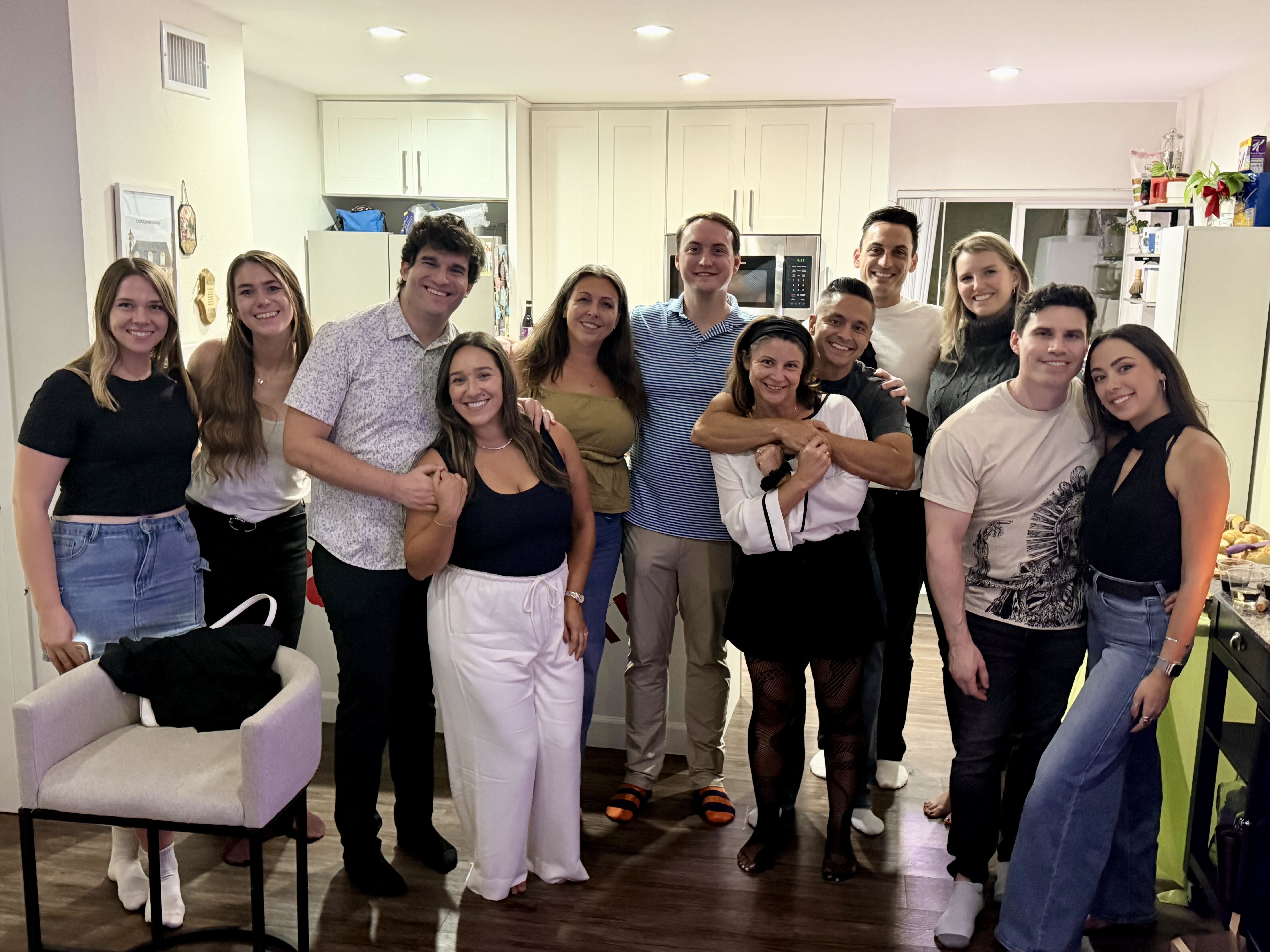 Group of young adults standing and smiling together